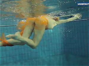 Yellow and red dressed teen underwater